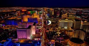 Stunning aerial view of Las Vegas Strip glowing at night with vibrant neon lights and bustling nightlife.