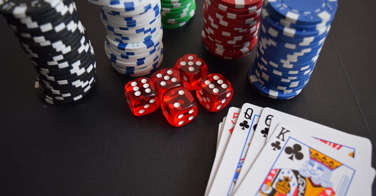 A vibrant display of casino chips, dice, and playing cards set on a table, embodying chance and excitement.